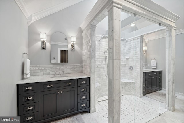 bathroom featuring vanity, crown molding, tiled shower, and ornate columns