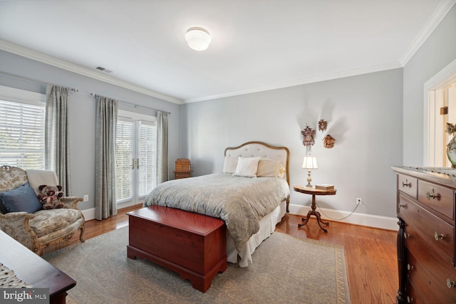 bedroom featuring hardwood / wood-style flooring and crown molding