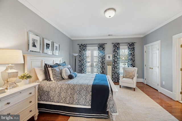 bedroom with crown molding and light hardwood / wood-style flooring