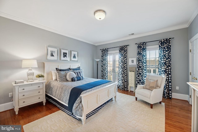 bedroom with ornamental molding and light wood-type flooring