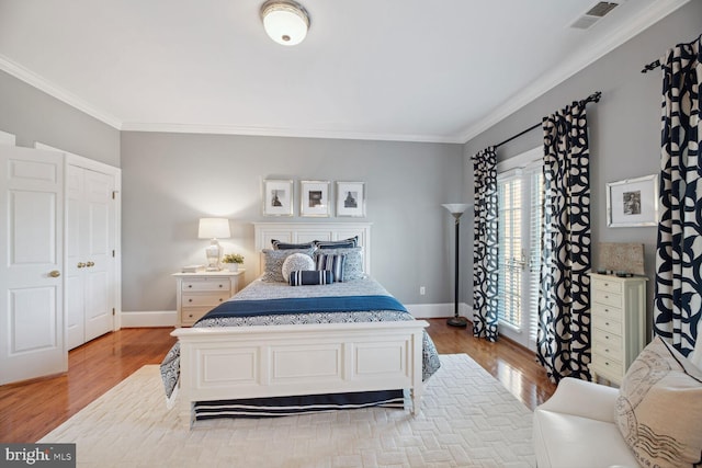 bedroom featuring crown molding and wood-type flooring