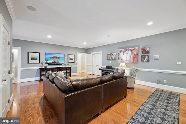 living room with light hardwood / wood-style flooring and ornamental molding