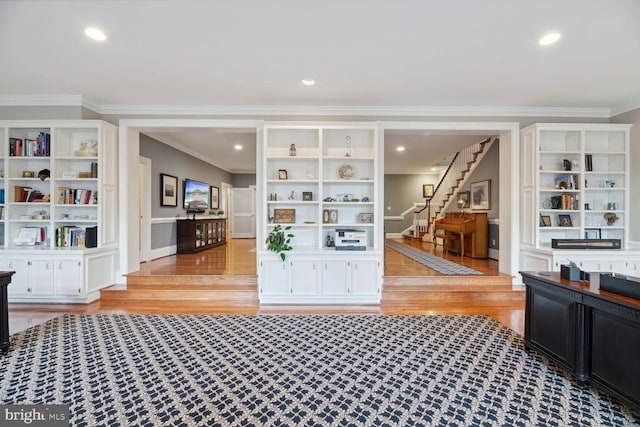 living room featuring ornamental molding and light hardwood / wood-style flooring