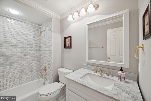 full bathroom featuring ornamental molding, toilet, tiled shower / bath combo, and vanity