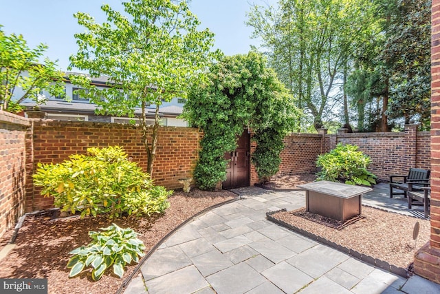 view of patio with a fire pit