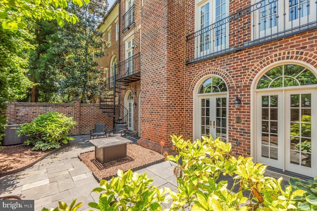 view of patio / terrace with french doors and an outdoor fire pit