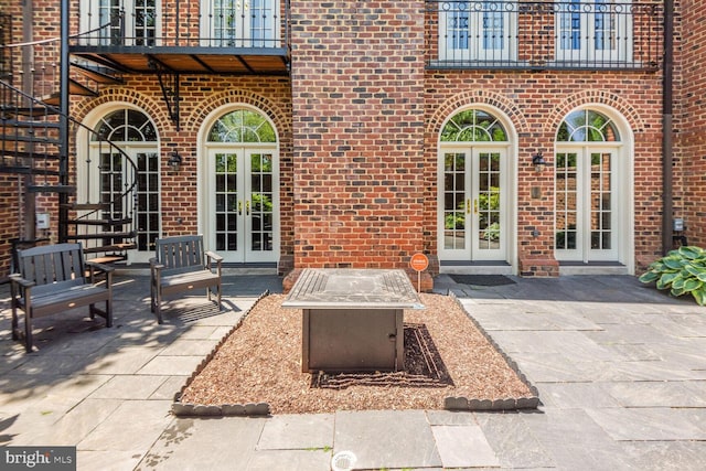 view of patio / terrace featuring french doors and an outdoor fire pit