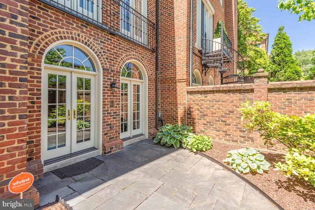 entrance to property featuring french doors and a patio