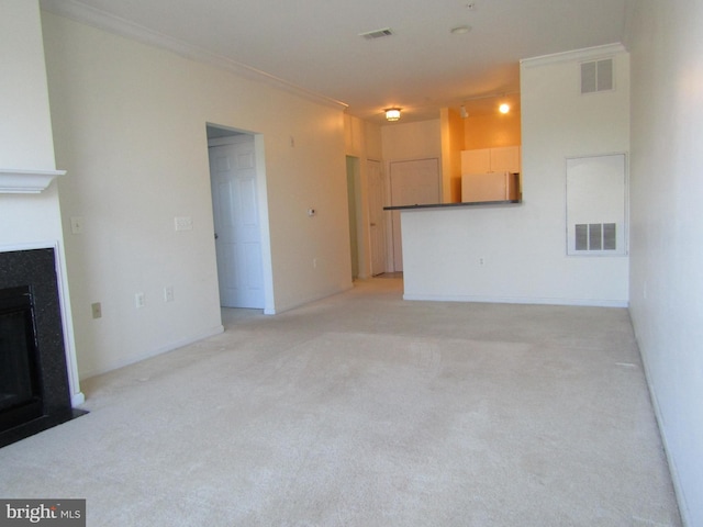 unfurnished living room featuring light colored carpet and ornamental molding