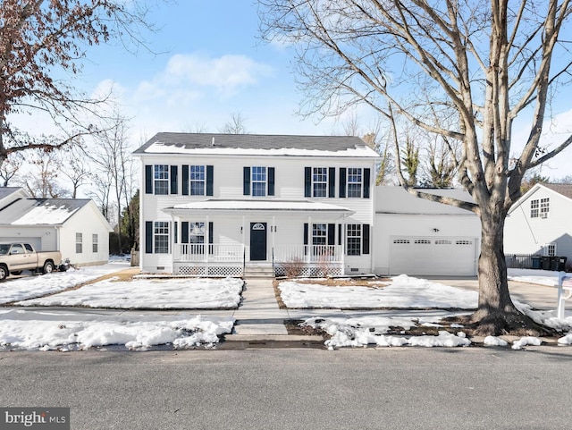 colonial home with a porch and a garage