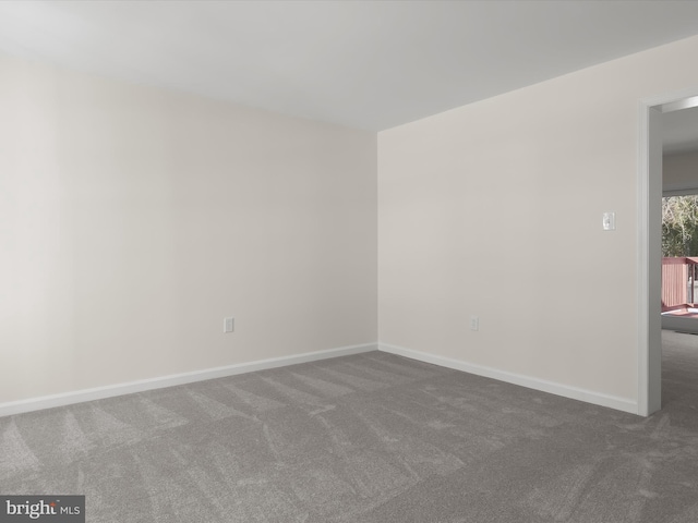 empty room with dark colored carpet