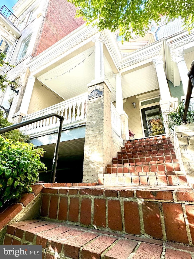 view of exterior entry with brick siding