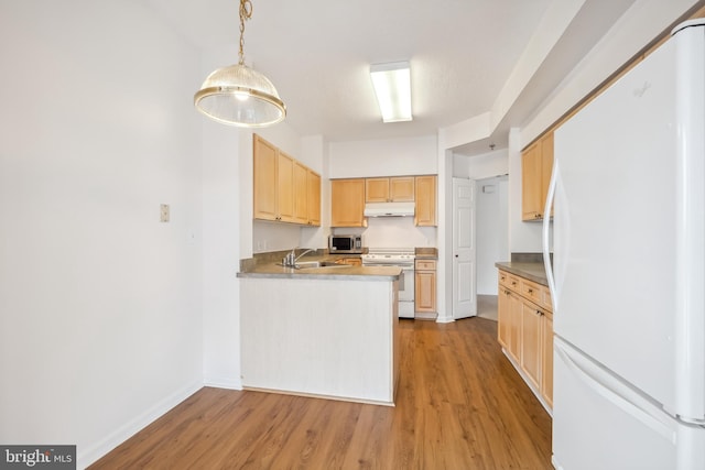 kitchen featuring sink, white appliances, light hardwood / wood-style flooring, hanging light fixtures, and light brown cabinetry