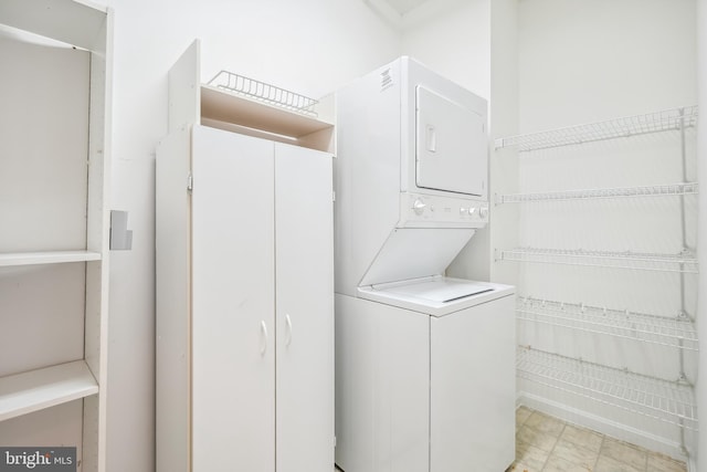 laundry area with stacked washer and clothes dryer