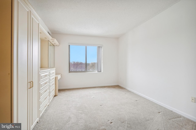 spacious closet featuring light colored carpet