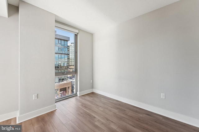 empty room with hardwood / wood-style floors