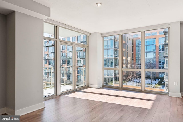 entryway with hardwood / wood-style floors and expansive windows