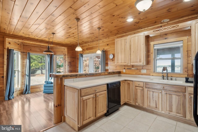 kitchen with wood ceiling, wood walls, black dishwasher, pendant lighting, and sink