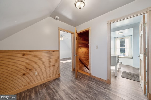 additional living space with vaulted ceiling and hardwood / wood-style floors