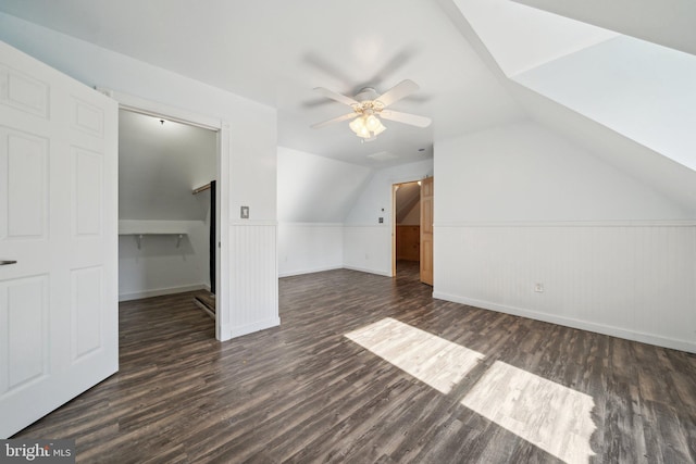 additional living space with ceiling fan, dark hardwood / wood-style floors, and vaulted ceiling