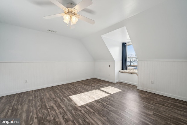 additional living space with ceiling fan, dark hardwood / wood-style flooring, and vaulted ceiling