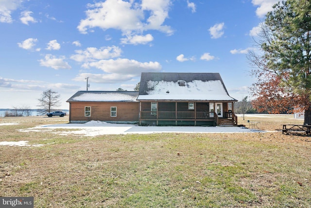 rear view of house with a yard