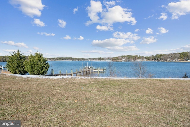 dock area featuring a lawn and a water view