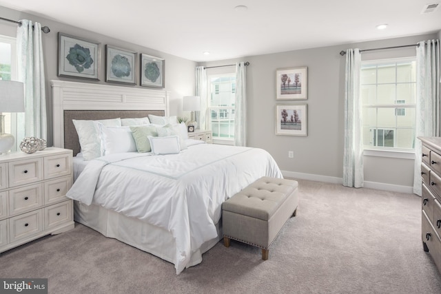 bedroom featuring light carpet