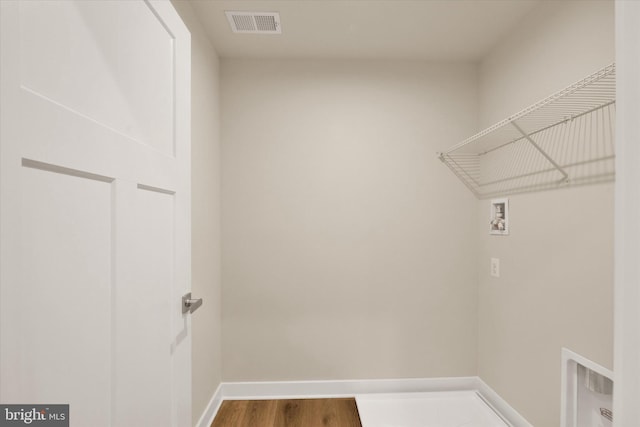 laundry room with washer hookup and wood-type flooring