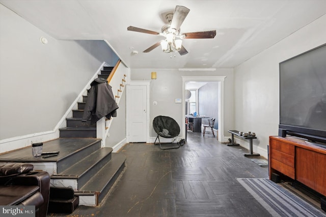 interior space with ceiling fan