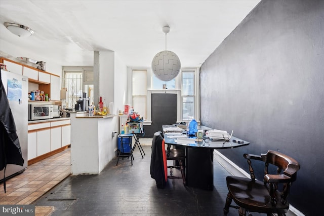 dining space with dark hardwood / wood-style floors