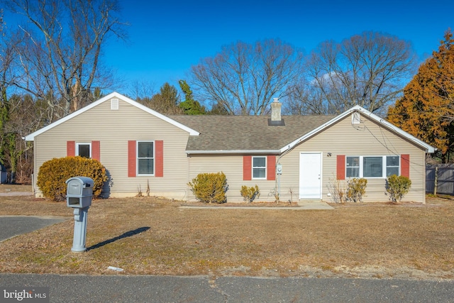 single story home with roof with shingles, a chimney, fence, and a front yard