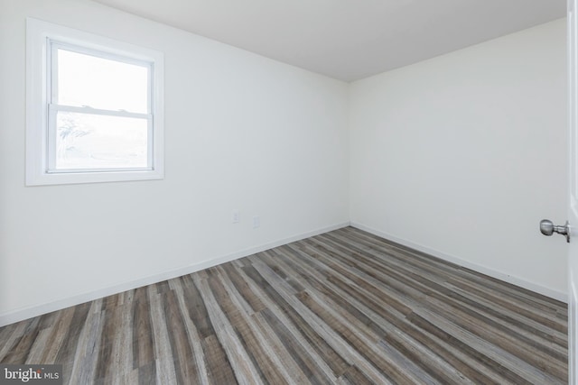 unfurnished room featuring dark hardwood / wood-style floors