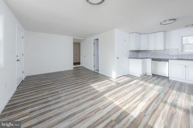 kitchen with white cabinetry, dishwasher, light wood finished floors, and decorative backsplash