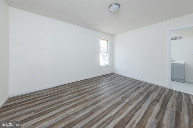 empty room with dark wood-type flooring