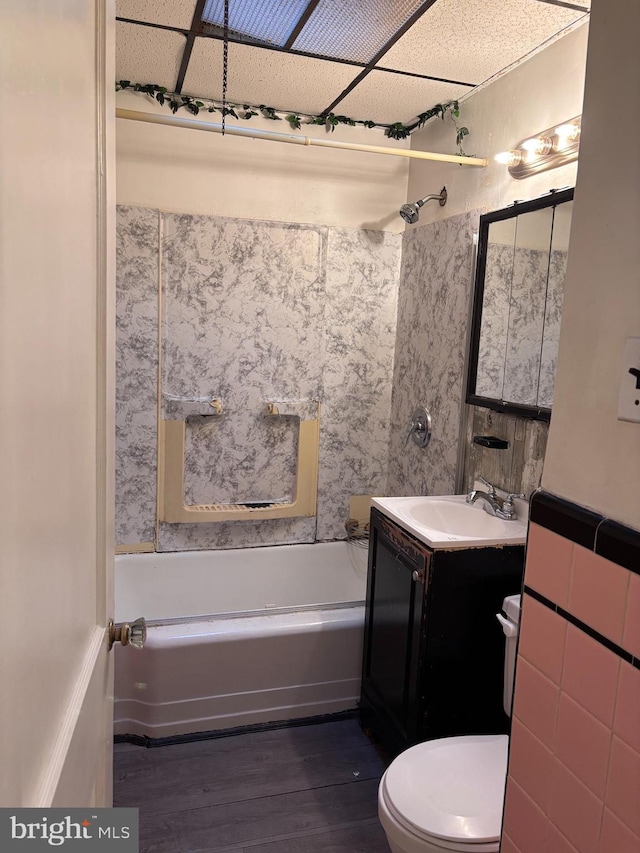 bathroom featuring toilet, vanity, and hardwood / wood-style floors