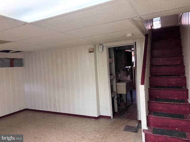 basement featuring a paneled ceiling