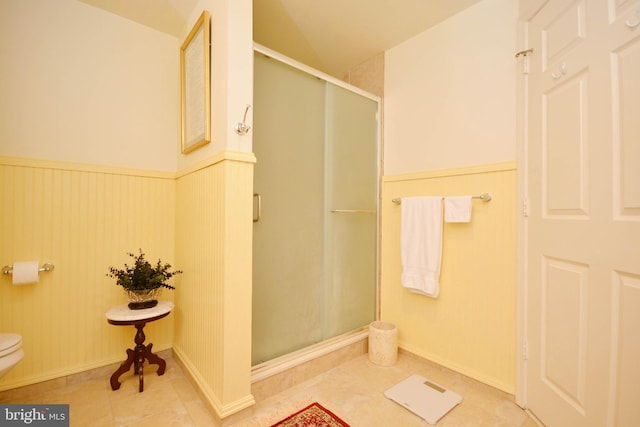 bathroom featuring an enclosed shower, tile patterned floors, and toilet