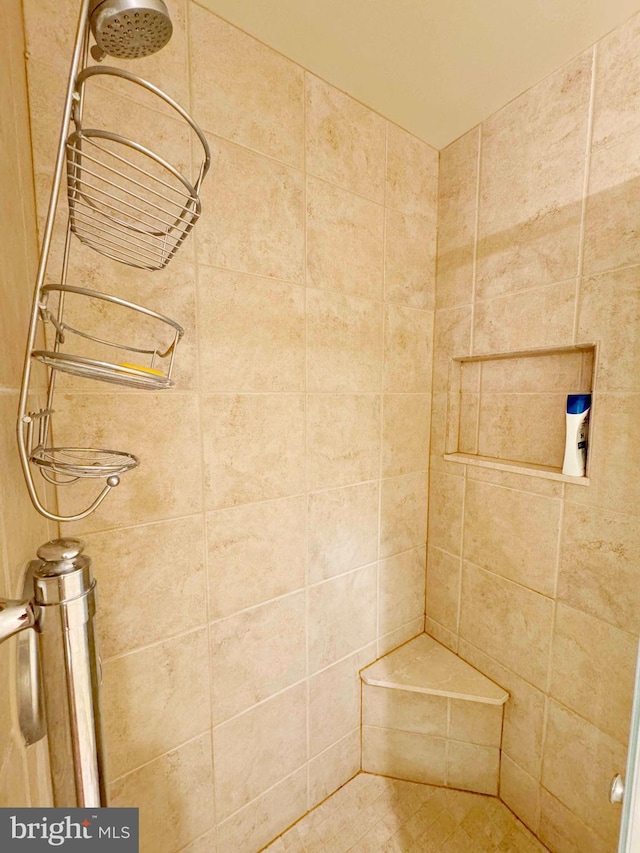 bathroom with tiled shower