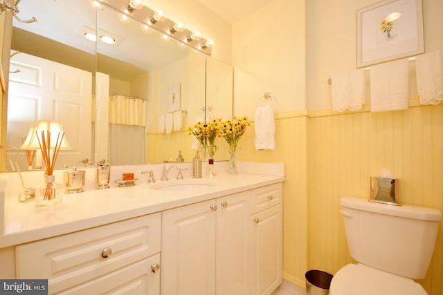 bathroom with toilet and vanity