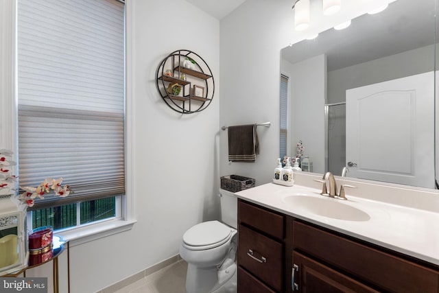 bathroom with toilet, vanity, tile patterned floors, and walk in shower