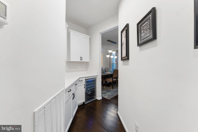 corridor featuring dark wood-type flooring and beverage cooler