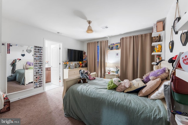 carpeted bedroom featuring ensuite bathroom