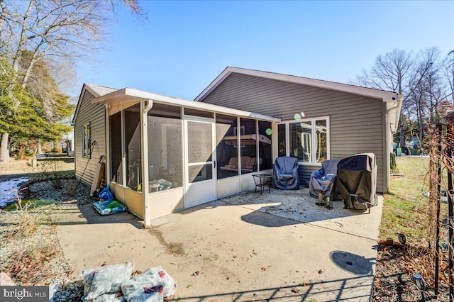 rear view of property featuring a patio area and a sunroom