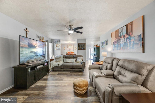 living room featuring hardwood / wood-style flooring, a textured ceiling, and ceiling fan