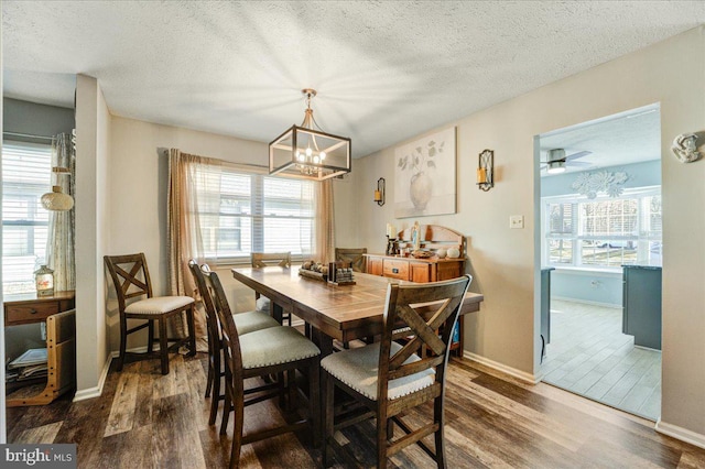 dining space featuring an inviting chandelier, a textured ceiling, and wood-type flooring