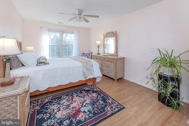 bedroom featuring ceiling fan and light hardwood / wood-style flooring