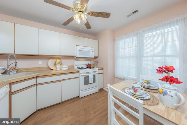 kitchen with sink, white cabinets, white appliances, ceiling fan, and light hardwood / wood-style floors