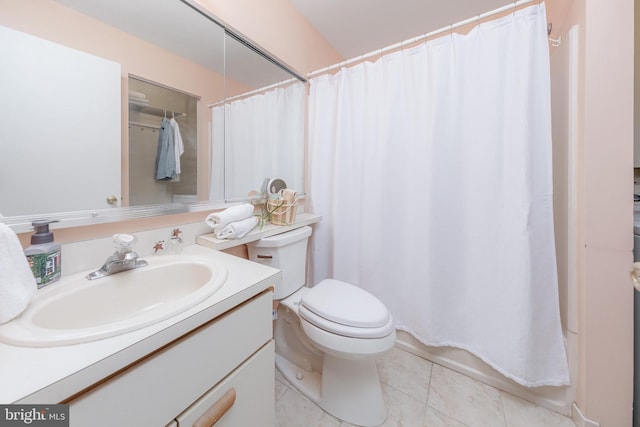 bathroom featuring vanity, tile patterned floors, and toilet