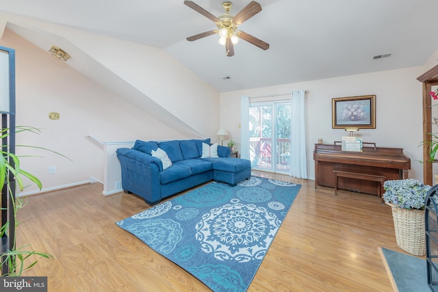 living room featuring vaulted ceiling, ceiling fan, and hardwood / wood-style flooring